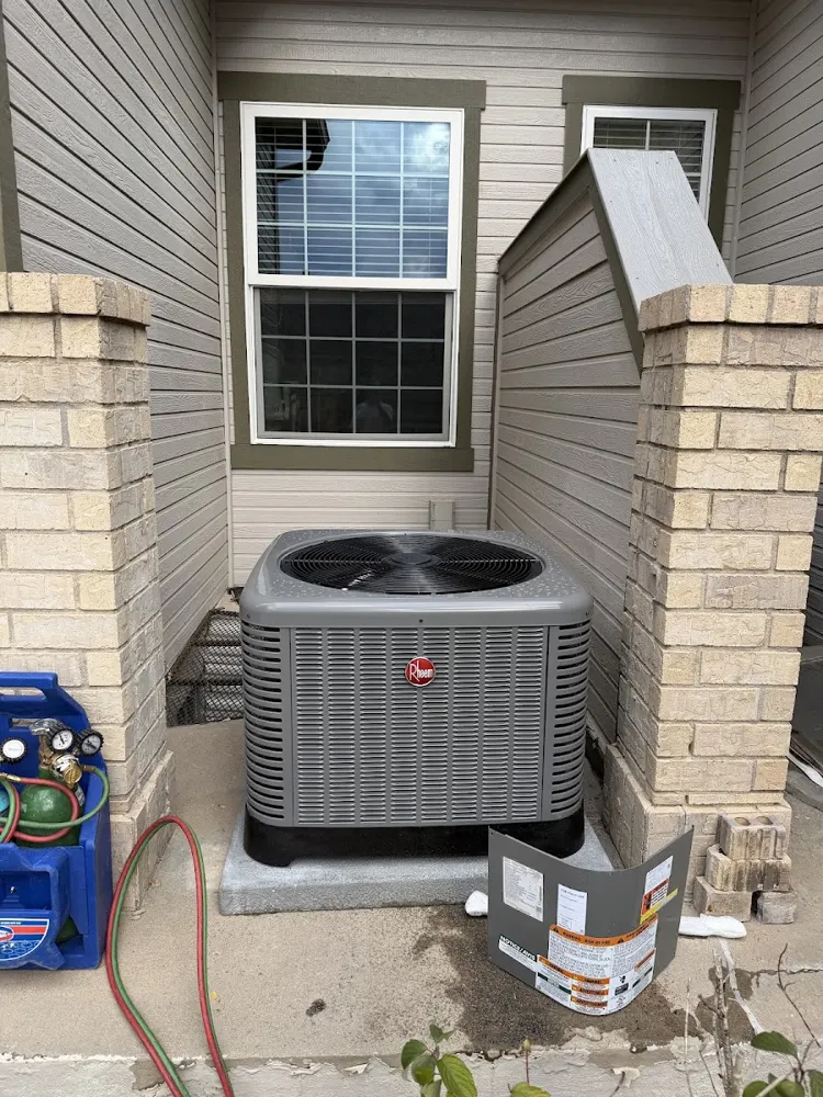 AC condenser installed beside the home