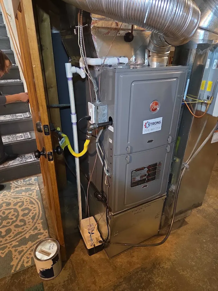 Furnace install next to a finished staircase