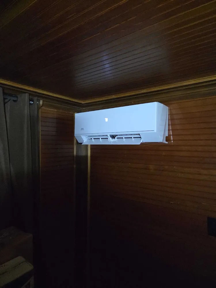 Ductless mini-split head in a wood-paneled room